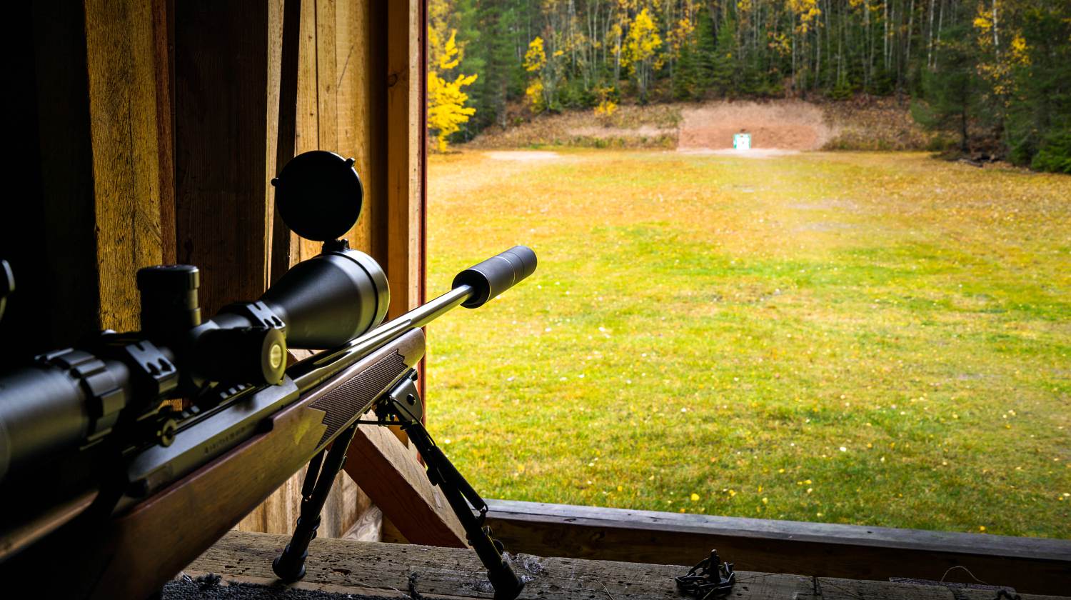 Feature | Sniper rifle with silencer and scope at shooting range | Long Distance Shooting: Choosing Your Gun And Ammo