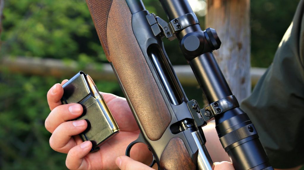 Feature | A hunter loading his hunting rifle gun with magazine | My Favorite Long Distance Rifle Cartridges