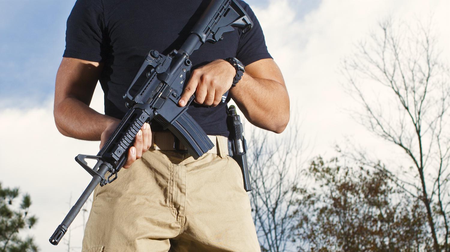 man carrying AR15 rifle | Why The AR15 Is One Of The BEST Firearms You Could Ever Buy | AR15 | ar 15 parts | Featured