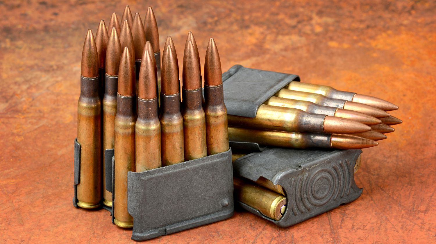 World war II M1 clips and 30-06 ammunition on rusty background | Modern Shooter: .30-06 Springfield | Featured