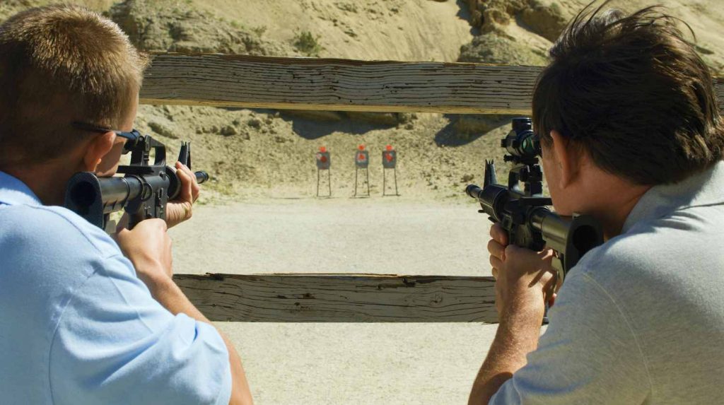 Feature | Men aiming rifles at firing range | Rifle Shooting Tips & Techniques | Surprising Things New Rifle Shooters Need to Know