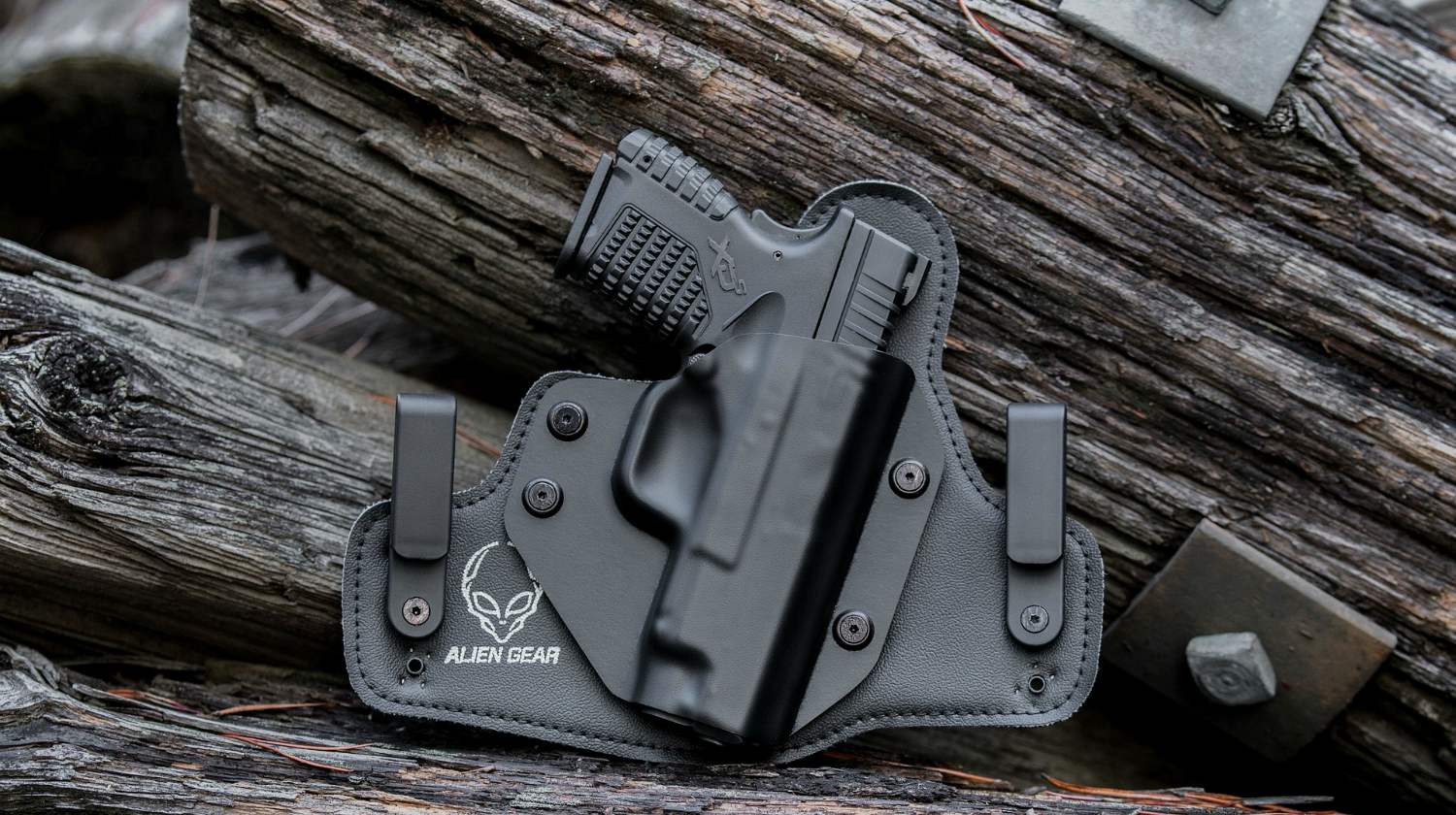 Feature | Black handgun in the woods | Self-Defense Weapons: Guns You Need For When SHTF