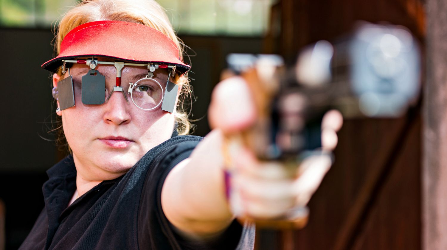 Featured | Woman concentrating on sport shooting training | How To Fix The Top Pistol Shooting Errors: Part One