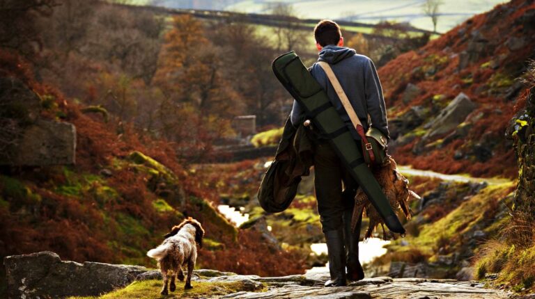 Feature | Hunter with his dog going to forest | Hunting Guns | Top Rifles, Shotguns, And Handguns For Hunting