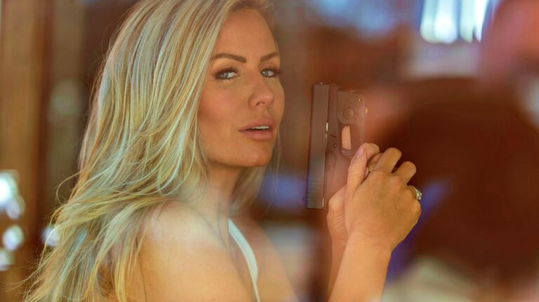 Featured | A beautiful blonde model holds a pistol for protection on a sunny day | One Woman's Guide To Girl Guns
