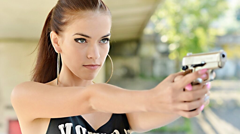 Feature | Beautiful woman with gun | What's The Best Handgun For Women?