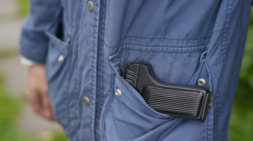 Feature | A man legally carries a firearm in his pocket for protection | The 5 Best Pocket Sized Pistols Available