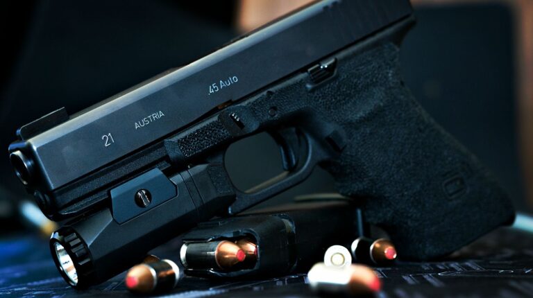 Feature | Glock 21 handgun with flash light and hollow point bullets | Mastering The Glock Trigger