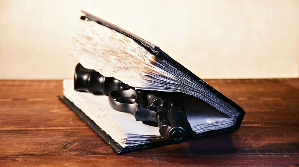 Feature | Black revolver in a book | Blue Book of Gun Values | Gun Carrier