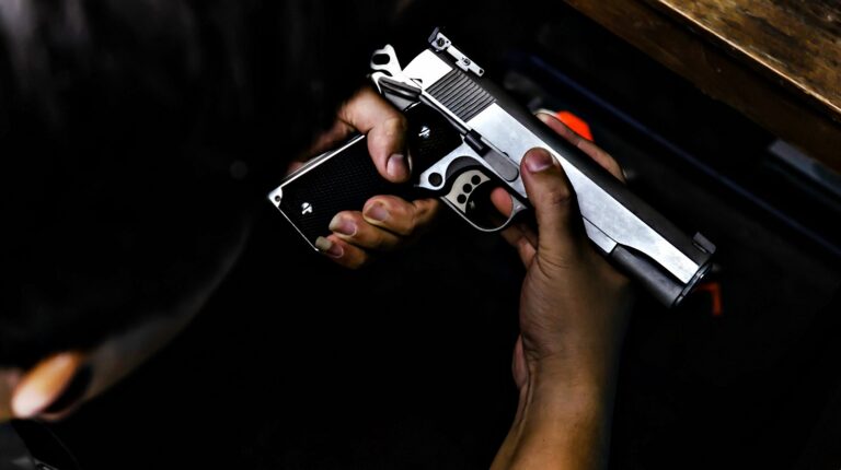 Gun in the hands of a man | Why It's A Bad Idea To Put A Gun In The Trash | Featured