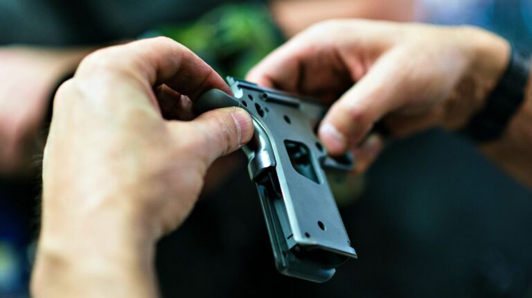 Gunsmith working on handgun close up fitting parts | How To Become A Gunsmith | Featured
