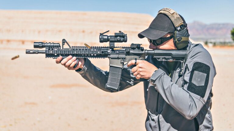Man with gray jacket shooting black rifle on range in desert | How To Protect Your Hearing When Shooting | Featured