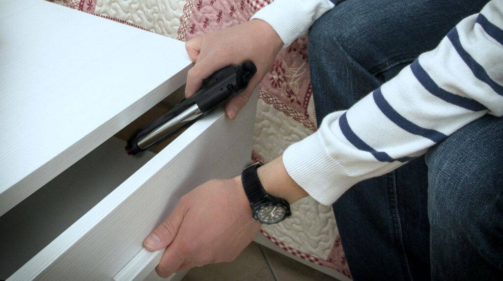 man hiding gun inside the drawer | How To Conceal A Gun At Home Or In A Vehicle | how to conceal a gun | concealed carry techniques and secrets of the pros | Featured