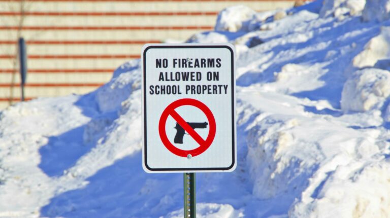 Feature | No firearms allowed on school property sign outside a school in the snow | No Guns Allowed Signs | What A Responsible Gun Owner Can Do