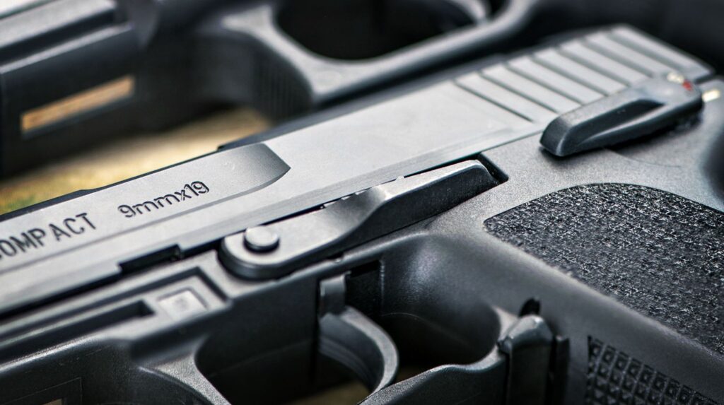 Feature | Three guns on a wooden table | 9mm vs .40 vs .45 | Which is Better for Self Defense?