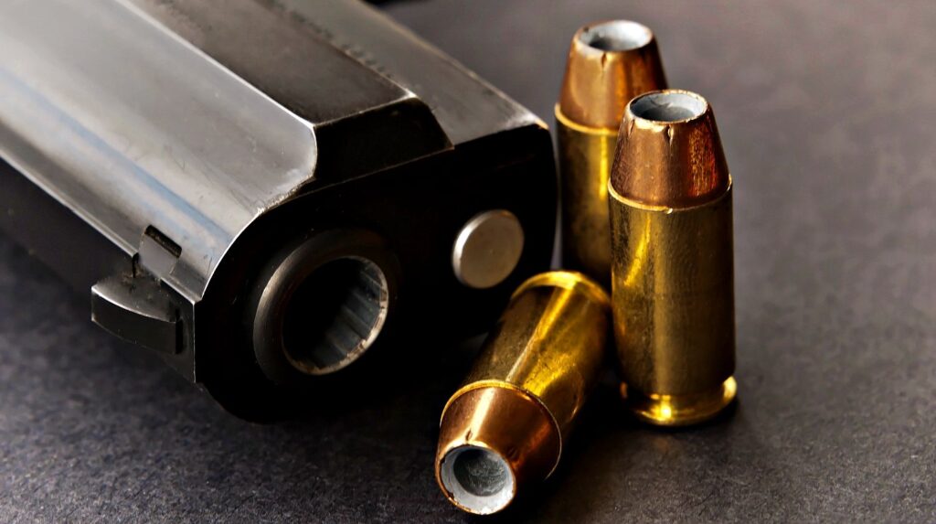 Feature | Bullets next to black handgun | Modern Self Defense: .357 Sig