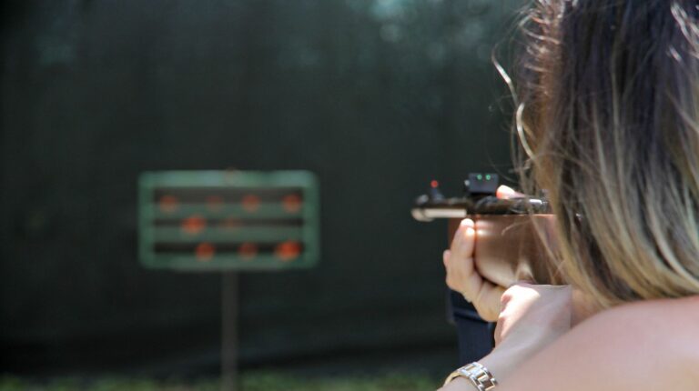Feature | Back view of a woman practice shooting | Best Home Defense Guns | When The Cops Are Minutes Away